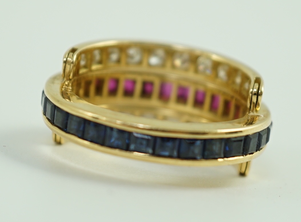 An 18k gold, ruby, sapphire and diamond set triple band swivel ring